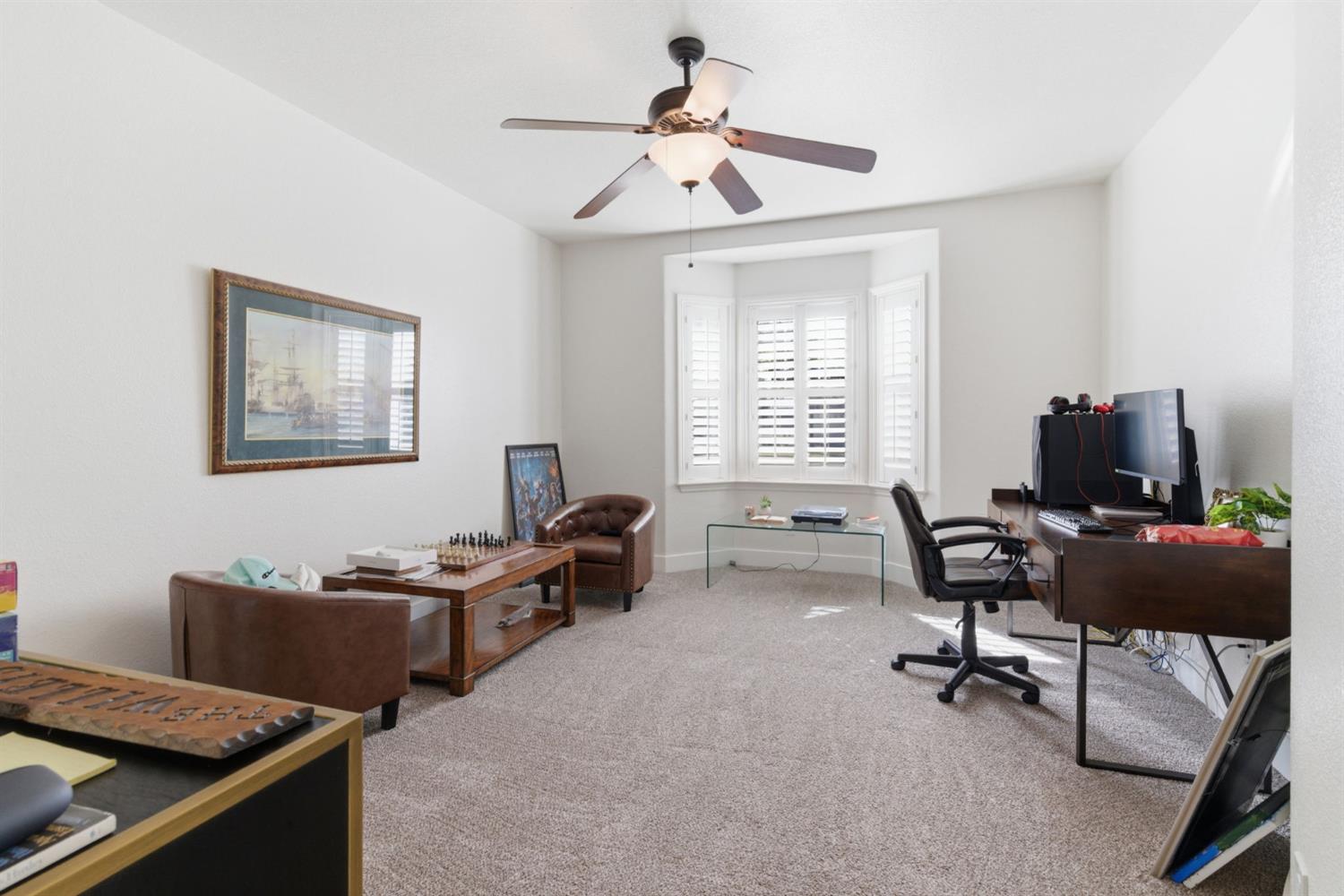 243 John Kamps Way Ripon, CA 95366 - Photo 12 of 62 a view of a workspace with furniture and a window