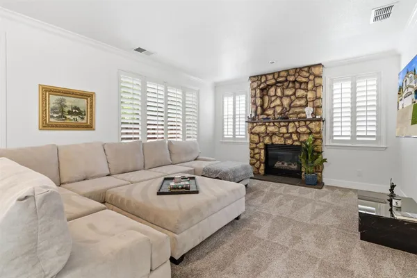 a living room with furniture and a wall painting