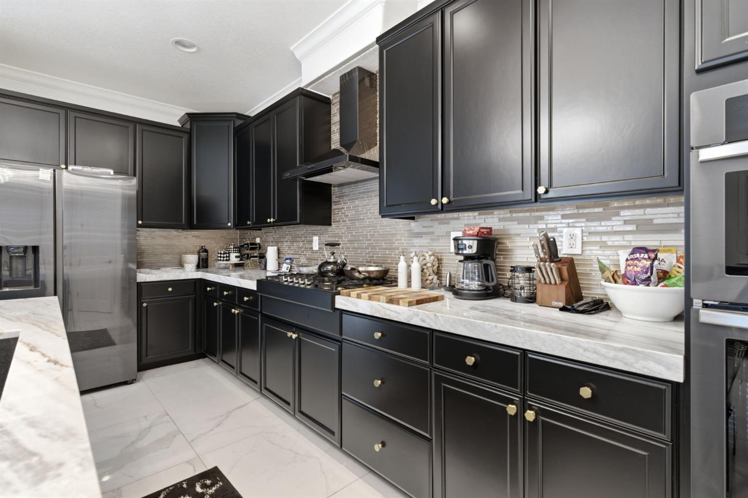 243 John Kamps Way Ripon, CA 95366 - Photo 22 of 62 a kitchen with stainless steel appliances granite countertop a sink stove and refrigerator