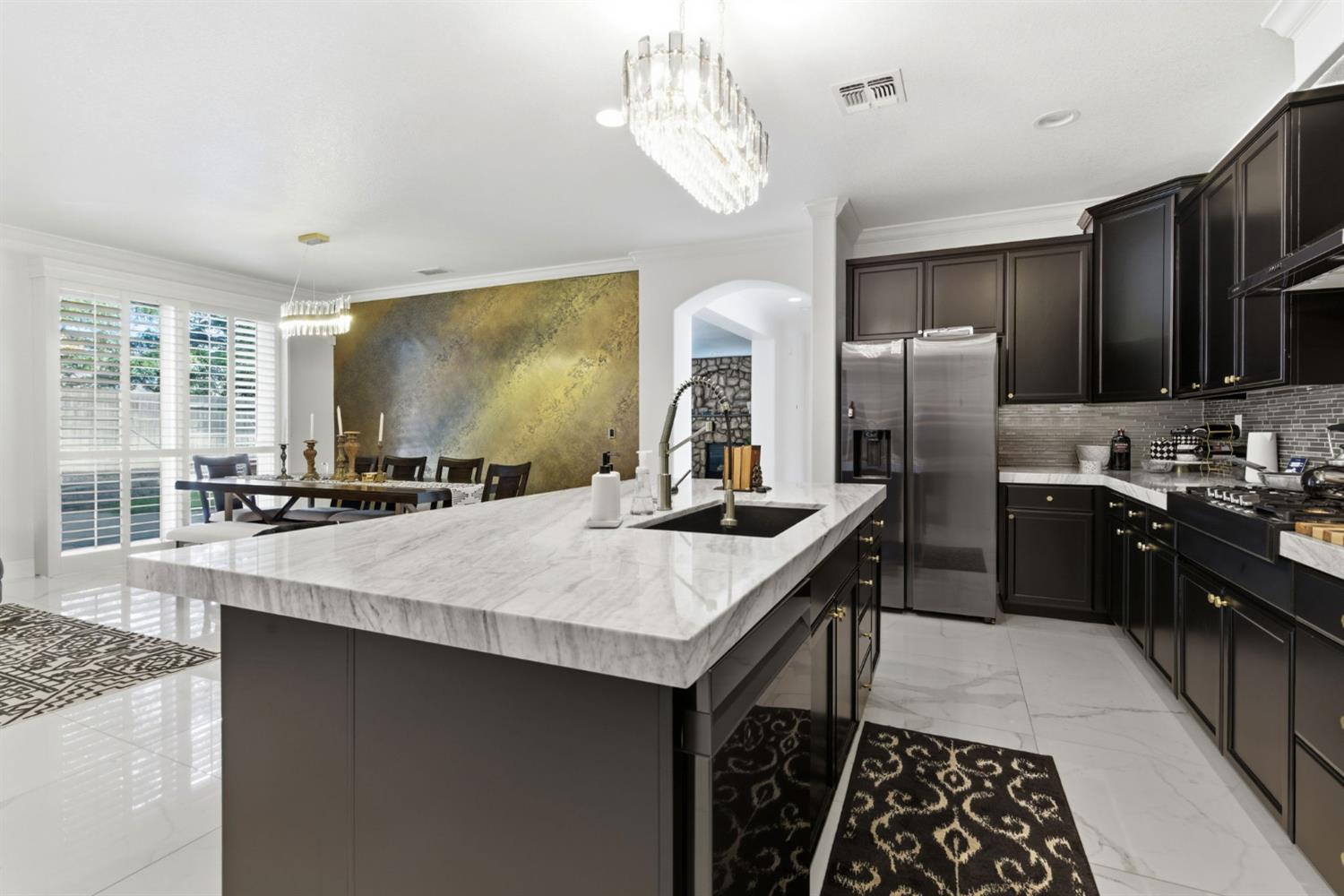 243 John Kamps Way Ripon, CA 95366 - Photo 23 of 62 a kitchen with stainless steel appliances granite countertop a sink a stove and a refrigerator