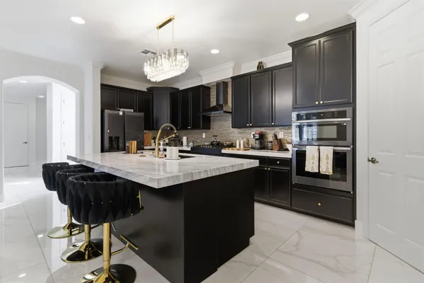 a large living room with kitchen island furniture and a view of kitchen