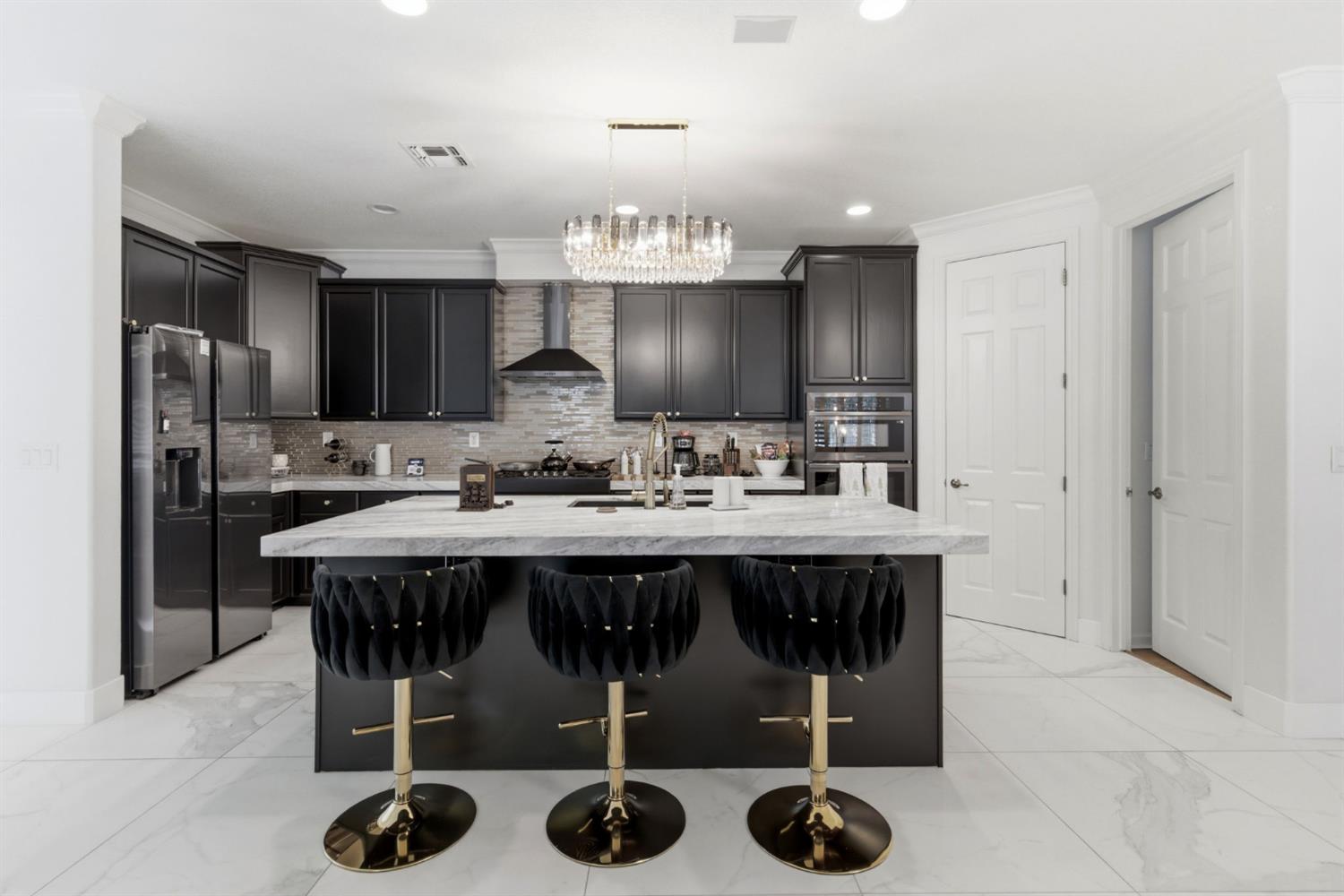 243 John Kamps Way Ripon, CA 95366 - Photo 25 of 62 a kitchen with a table chairs sink and refrigerator