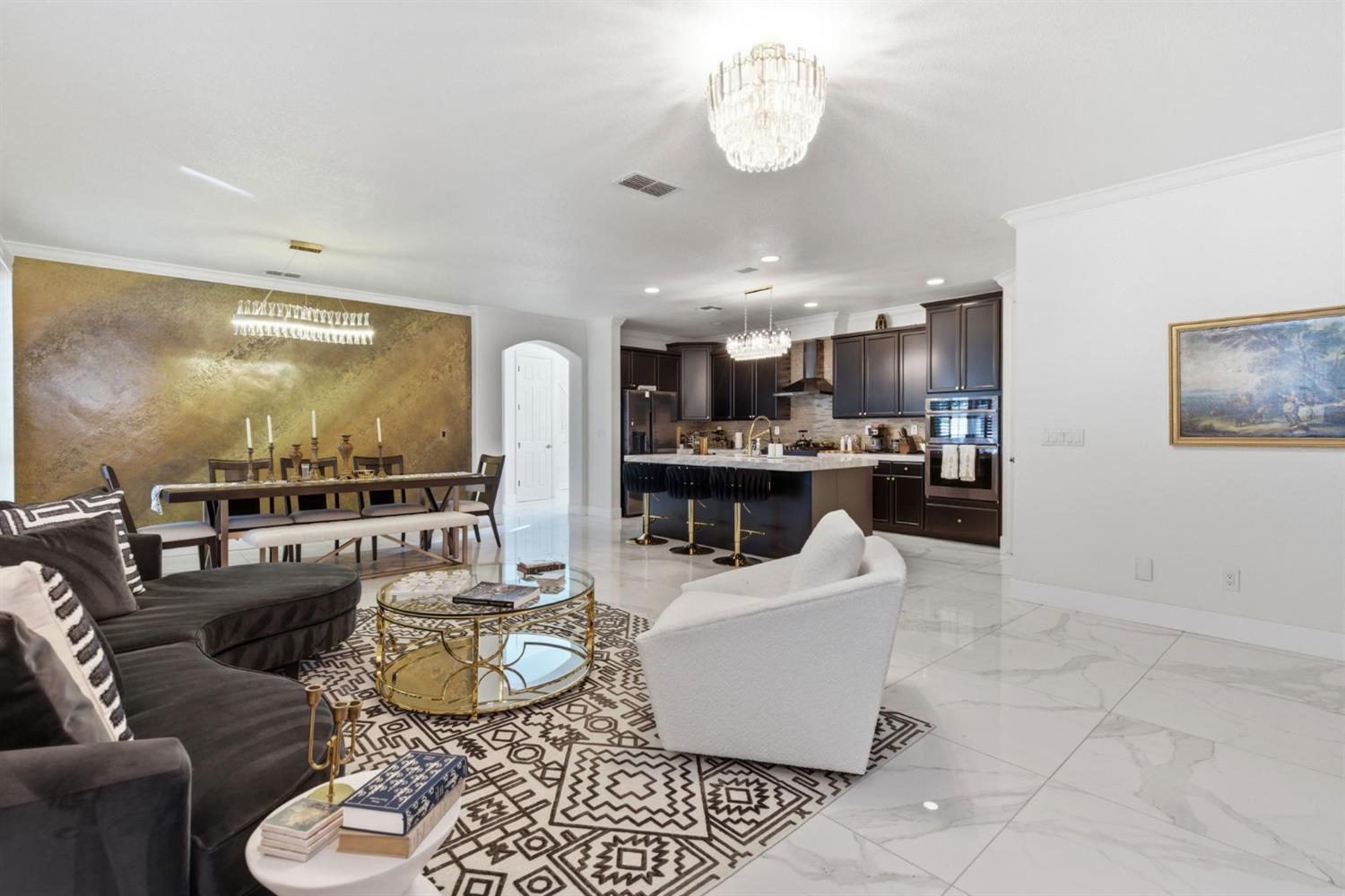 243 John Kamps Way Ripon, CA 95366 - Photo 28 of 62 a large living room with kitchen island furniture and a view of kitchen