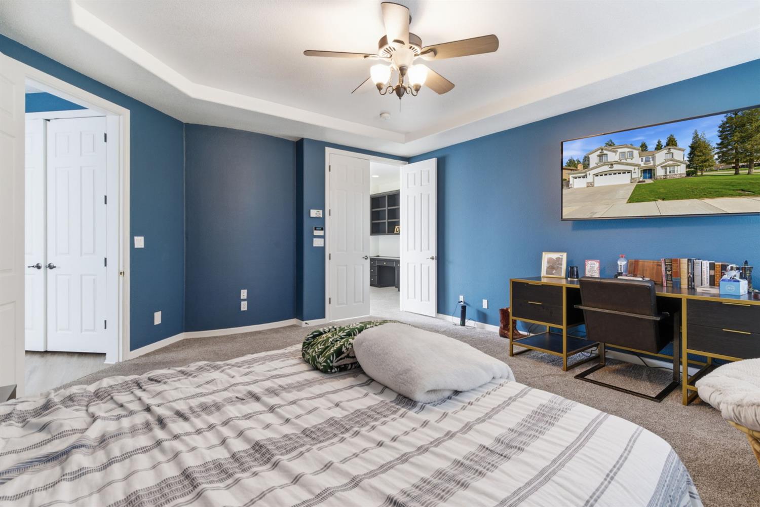 243 John Kamps Way Ripon, CA 95366 - Photo 43 of 62 a bedroom with a bed and a chandelier