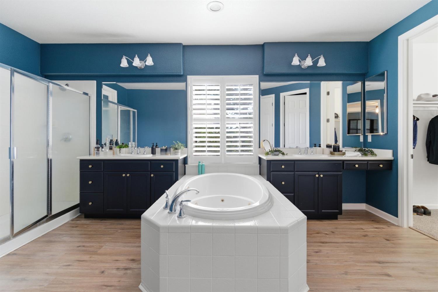 243 John Kamps Way Ripon, CA 95366 - Photo 44 of 62 a en suite bathroom with a sink and a large mirror