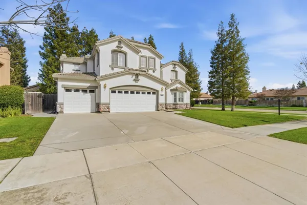 an aerial view of a house with a yard and a large pool