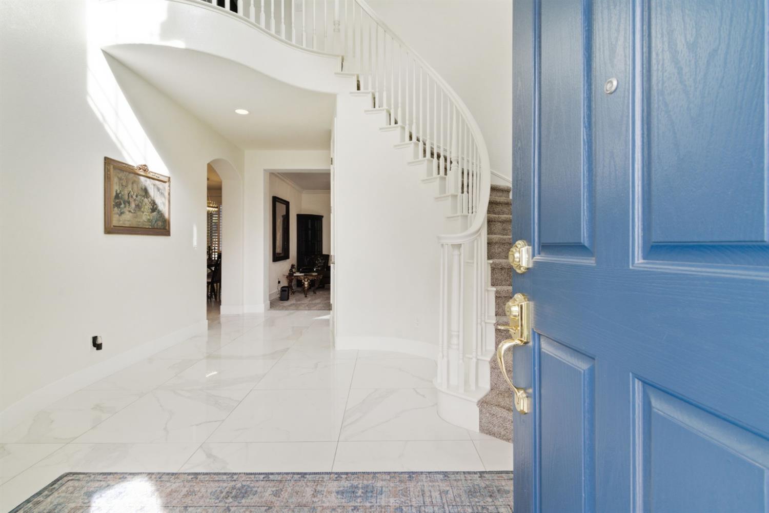 243 John Kamps Way Ripon, CA 95366 - Photo 8 of 62 a view of a hallway with wooden floor and staircase