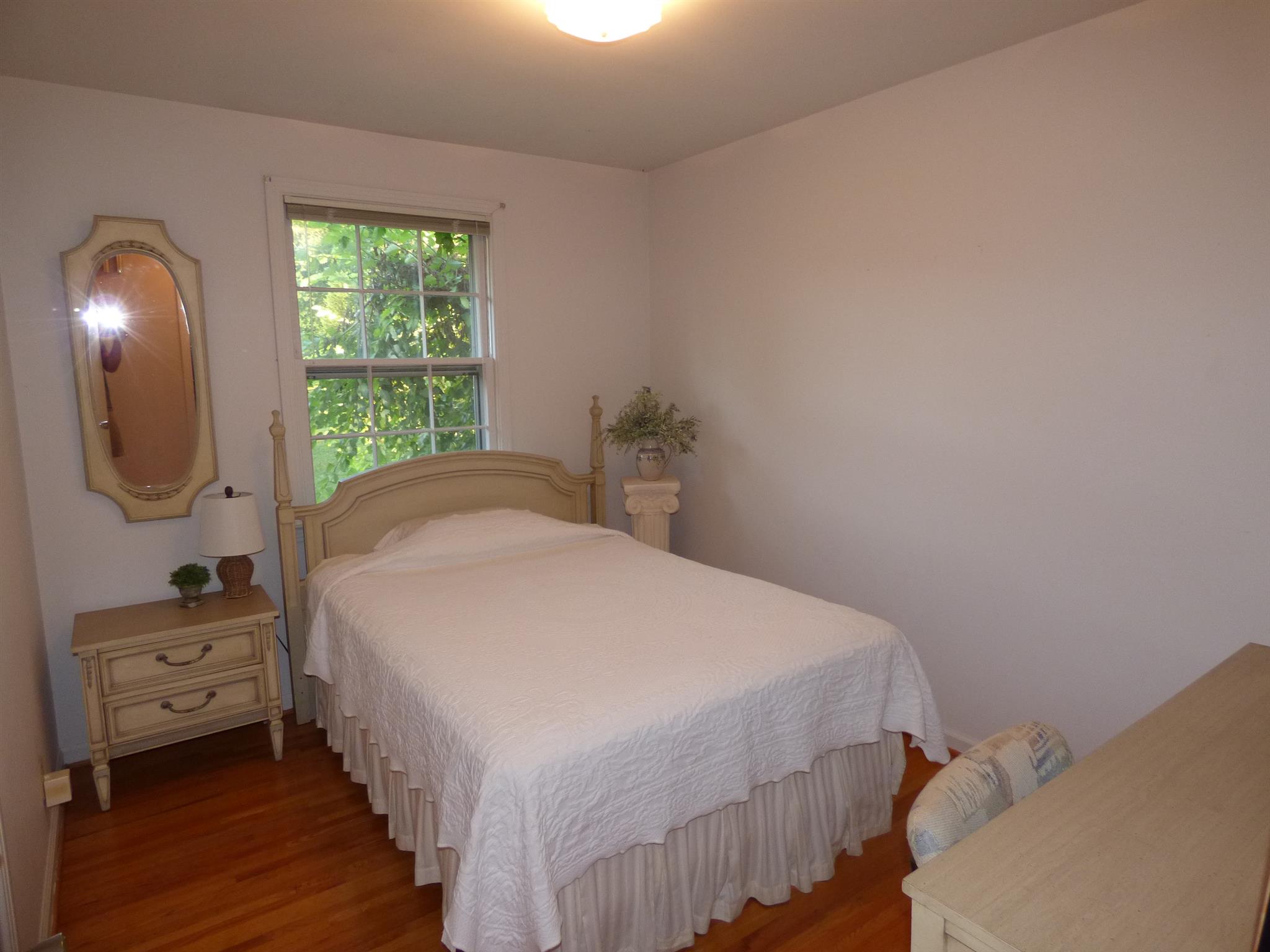 441 Excell Road Clarksville, TN 37043 - Photo 15 of 30 a bedroom with a bed a mirror and a window