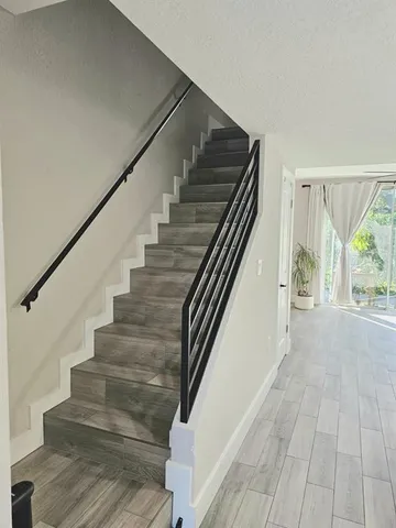 a view of entryway and hall with wooden floor