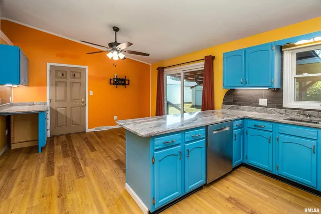 a kitchen with kitchen island granite countertop wooden cabinets and a sink
