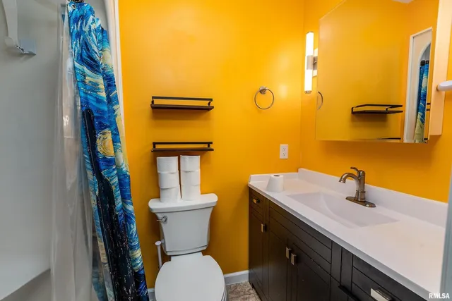 a bathroom with a sink a toilet and mirror