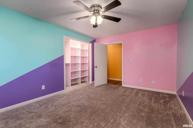 a view of a livingroom with a ceiling fan and window