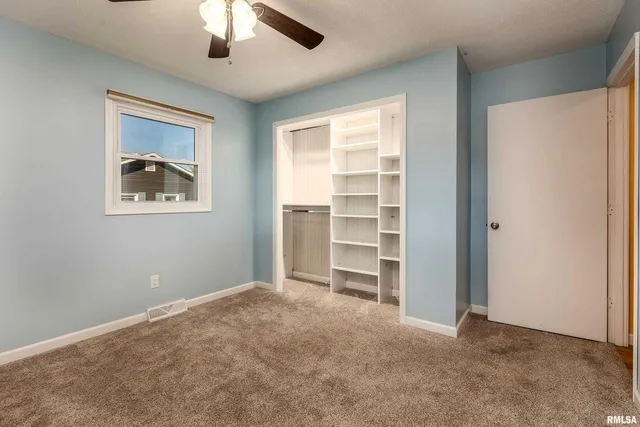 a view of room with a ceiling fan