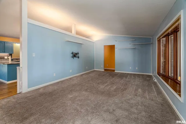 a view of an empty room and a window