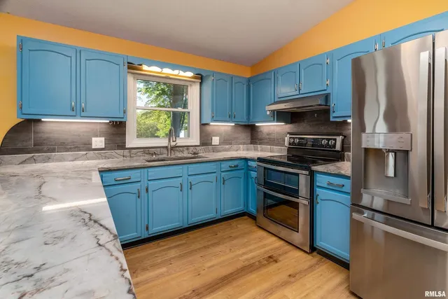 a kitchen with stainless steel appliances granite countertop a stove a sink dishwasher and a refrigerator