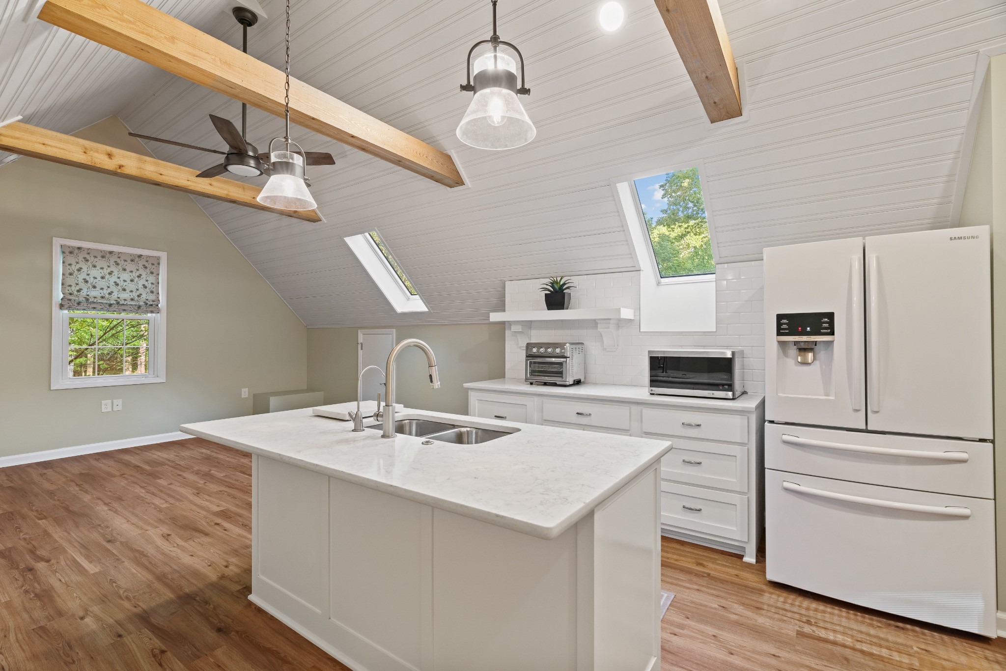 204 Hidden Lake Road Hendersonville, TN 37075 - Photo 50 of 67 a kitchen with a refrigerator a stove a microwave oven a sink and dishwasher with wooden floor