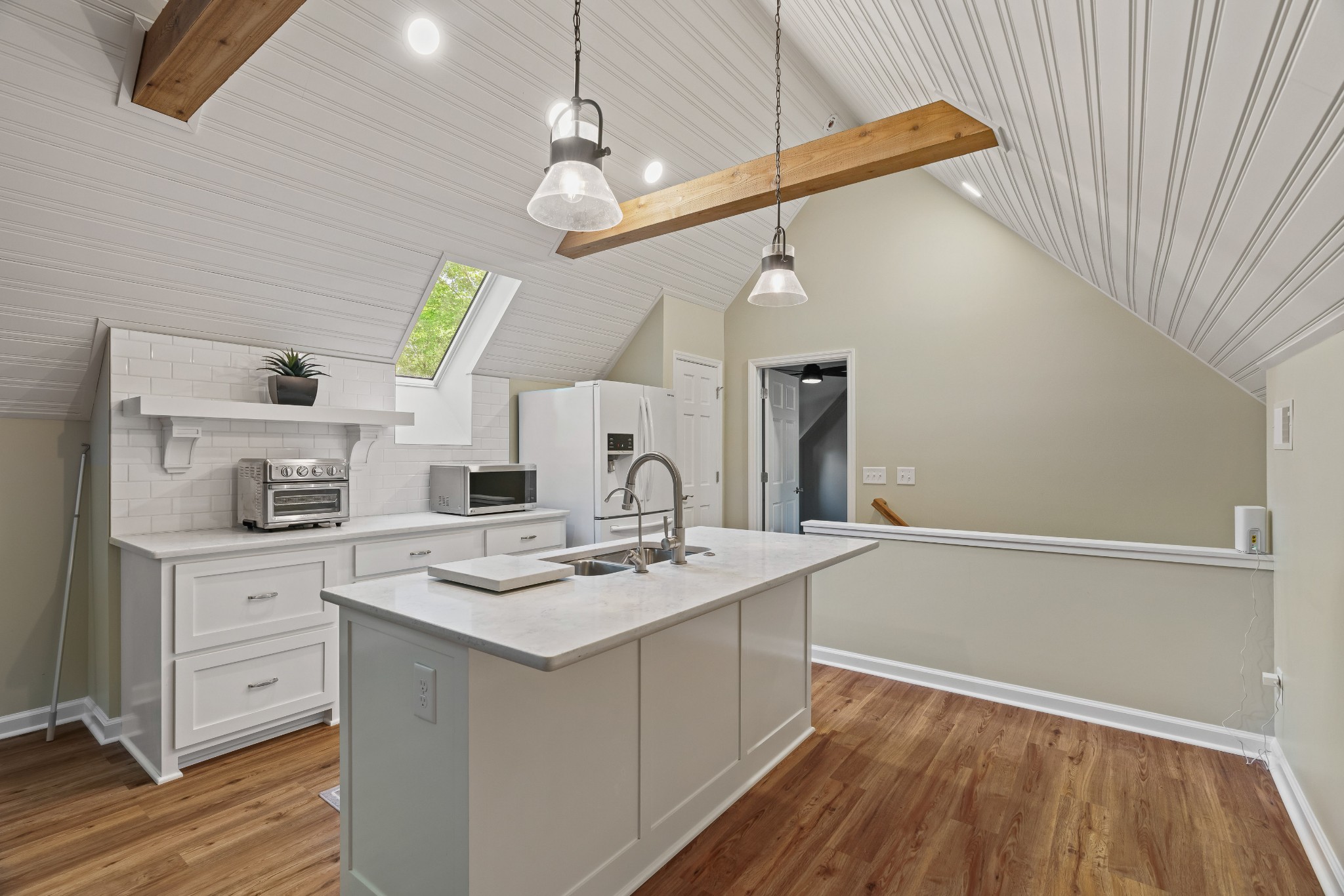204 Hidden Lake Road Hendersonville, TN 37075 - Photo 51 of 67 a kitchen with a sink dishwasher a stove and white cabinets with wooden floor