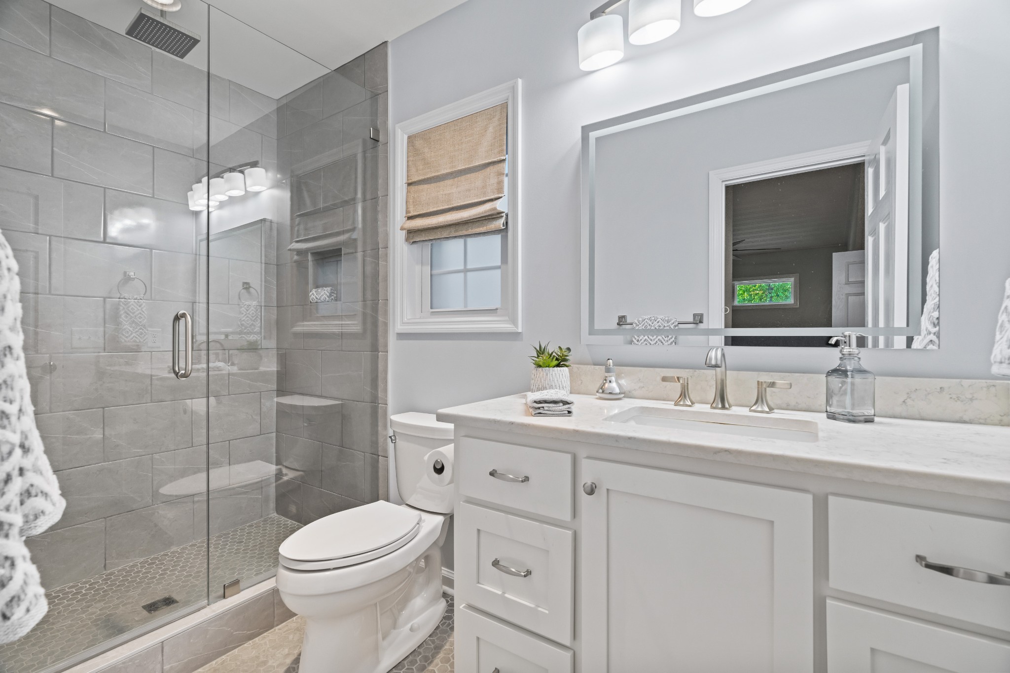 204 Hidden Lake Road Hendersonville, TN 37075 - Photo 55 of 67 a bathroom with a toilet a sink a glass door a shower a mirror and vanity