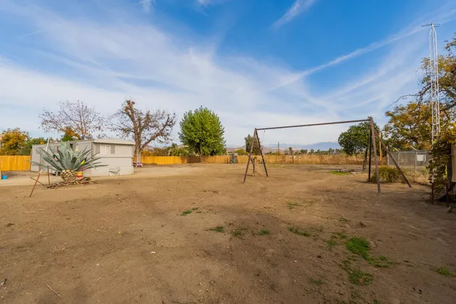 a view of a swimming pool with an outdoor seating and a yard