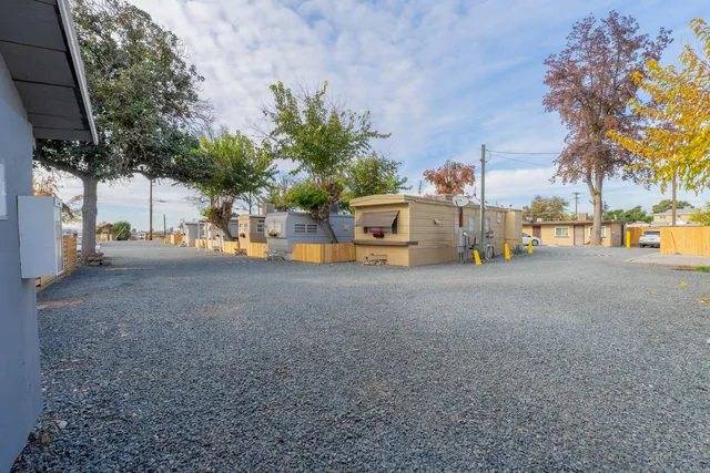 a view of a house with swimming pool and sitting area