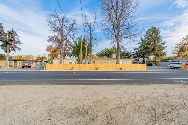 a view of backyard with tub and trees in the background