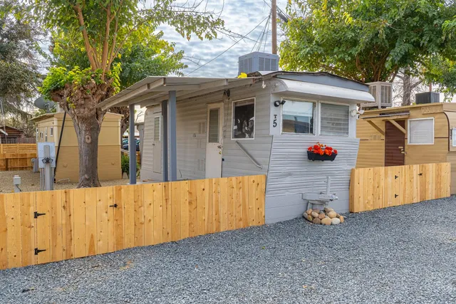 a view of a house with wooden fence