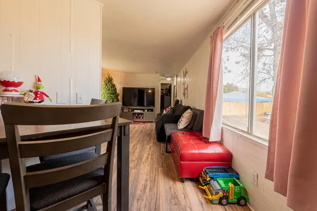 a living room with furniture a flat screen tv and a window