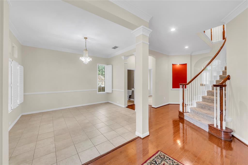 3920 Autumn Lane Bedford, TX 76021 - Photo 6 of 36 Entry foyer featuring wood-finish flooring and a curved staircase with carpeted treads