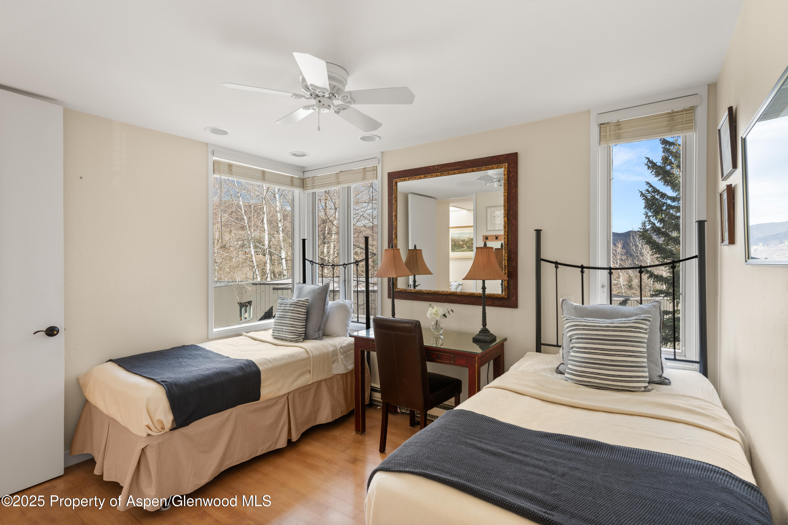 270 Meadow Ranch Road Snowmass Village, CO 81615 - Photo 12 of 17 a bedroom with a bed a mirror and a window