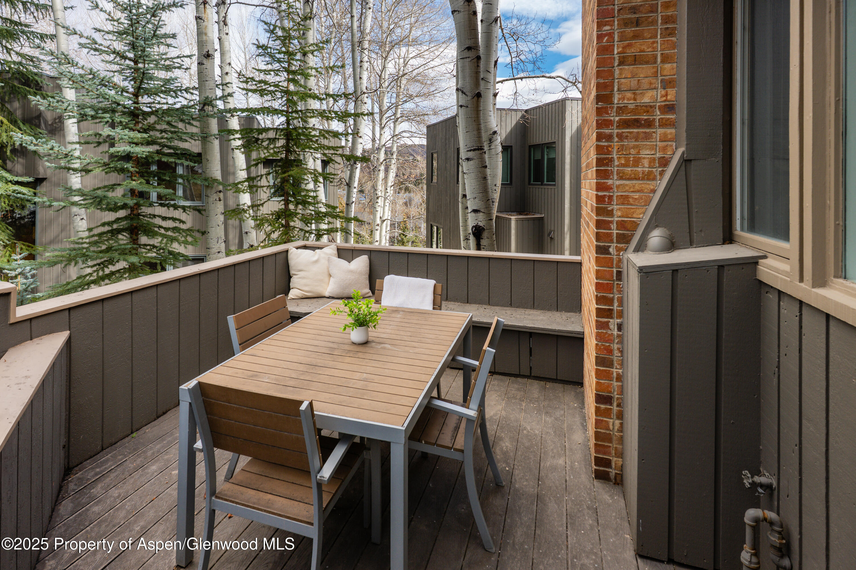 270 Meadow Ranch Road Snowmass Village, CO 81615 - Photo 14 of 17 a deck of a house with table and chairs