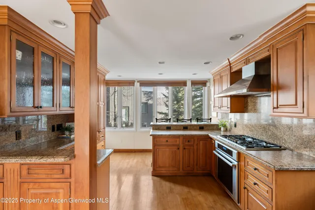 a kitchen with stainless steel appliances granite countertop a stove and a sink