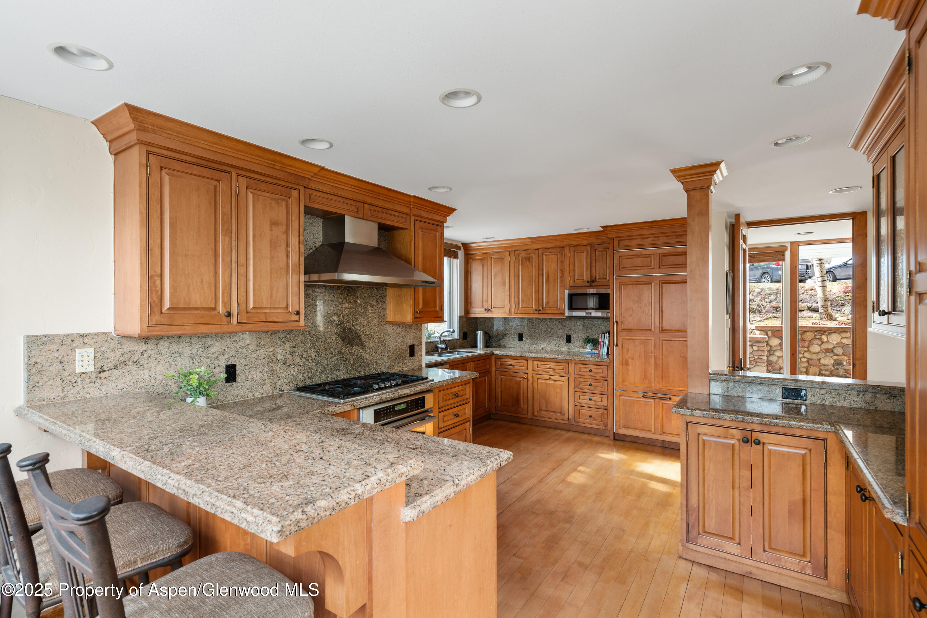 270 Meadow Ranch Road Snowmass Village, CO 81615 - Photo 5 of 17 a kitchen with stainless steel appliances granite countertop a sink stove and cabinets