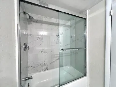 a bathroom with a glass shower door