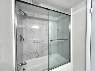 4215 North University Drive, Unit 214 Sunrise, FL 33351 - Photo 14 of 24 a bathroom with a glass shower door