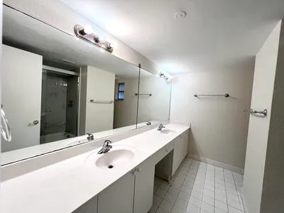 a bathroom with a double vanity sink and a mirror