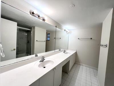 4215 North University Drive, Unit 214 Sunrise, FL 33351 - Photo 15 of 24 a bathroom with a double vanity sink and a mirror