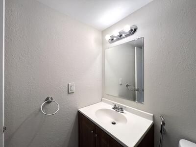 4215 North University Drive, Unit 214 Sunrise, FL 33351 - Photo 18 of 24 a bathroom with a sink vanity and mirror