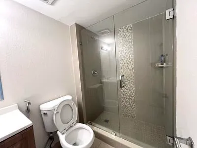 a bathroom with a toilet and a shower