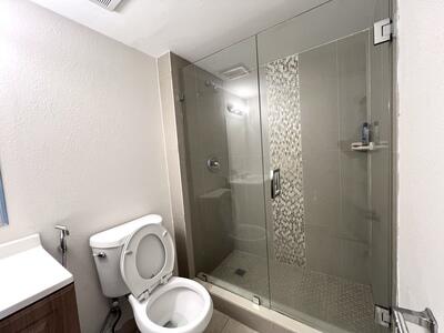 4215 North University Drive, Unit 214 Sunrise, FL 33351 - Photo 19 of 24 a bathroom with a toilet and a shower