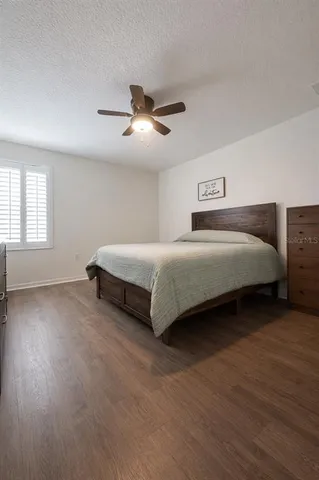 a spacious bedroom with a bed and window
