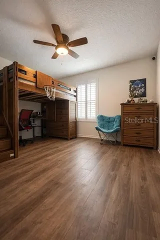 a living room with furniture and a ceiling fan