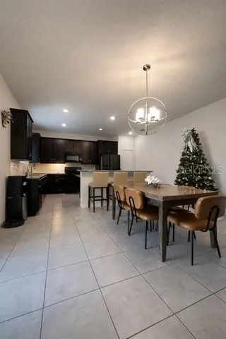 a kitchen with a dining table chairs and a stove