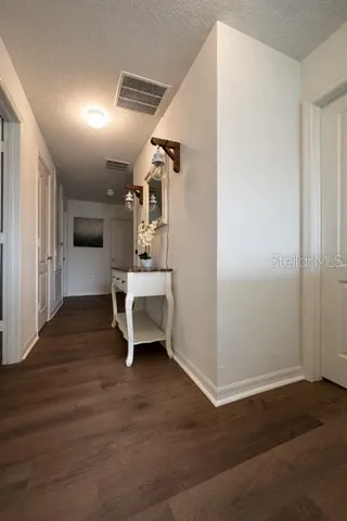 a view of a room with wooden floor and chairs