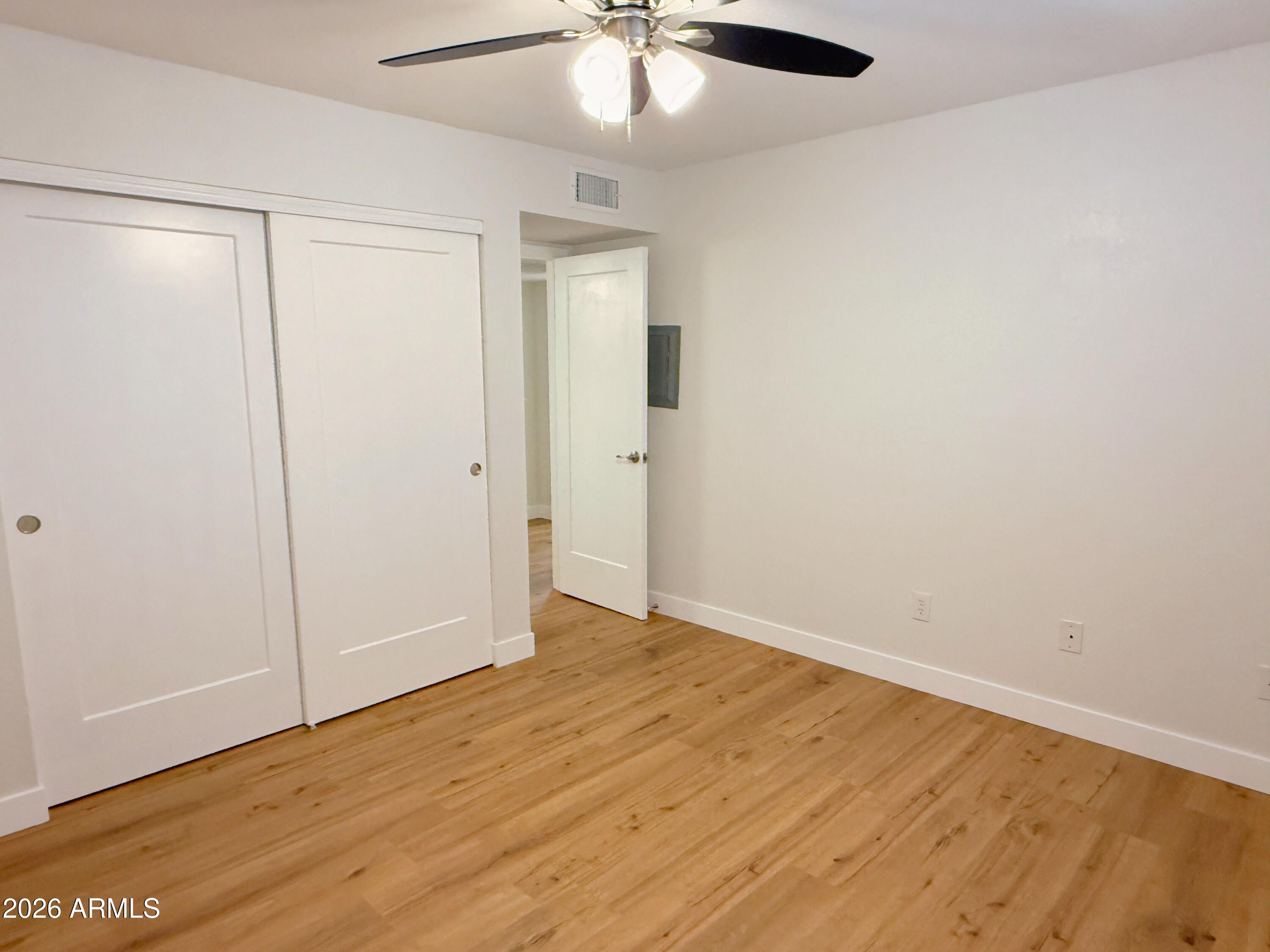 18202 North Cave Creek Road, Unit 148 Phoenix, AZ 85032 - Photo 12 of 19 wooden floor in an empty room