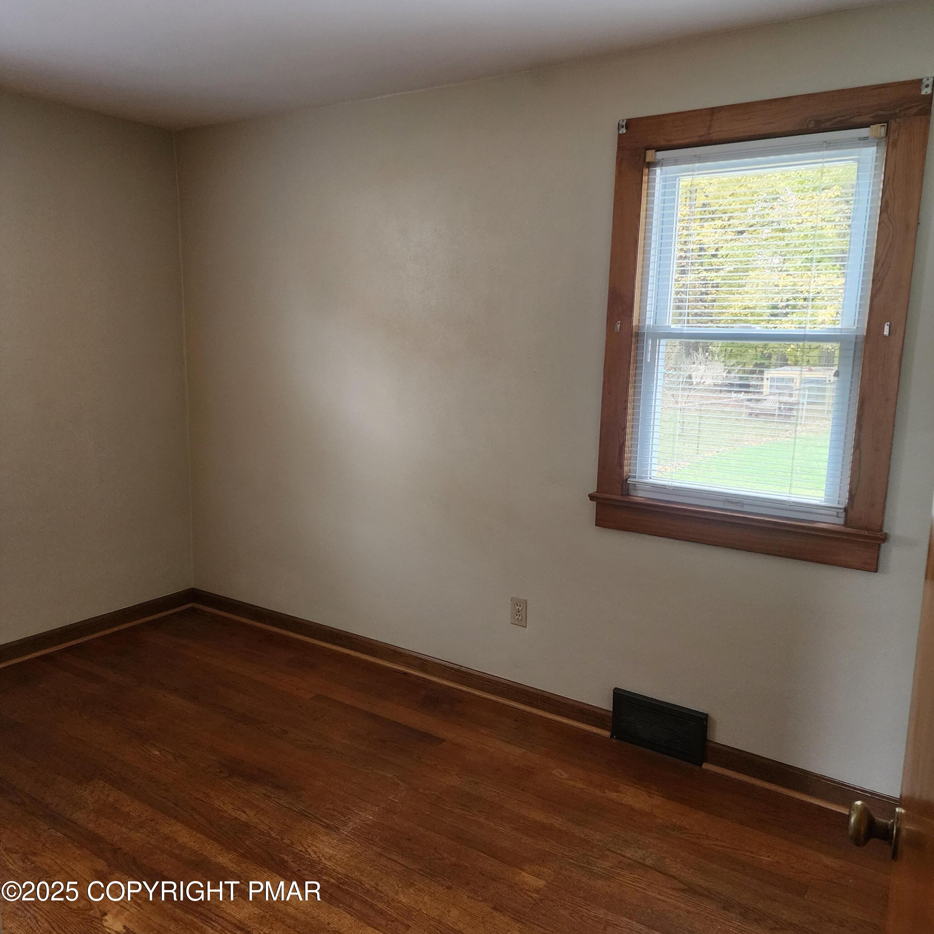 1069 Fritz Avenue Stroudsburg, PA 18360 - Photo 12 of 14 a view of an empty room with wooden floor and a window