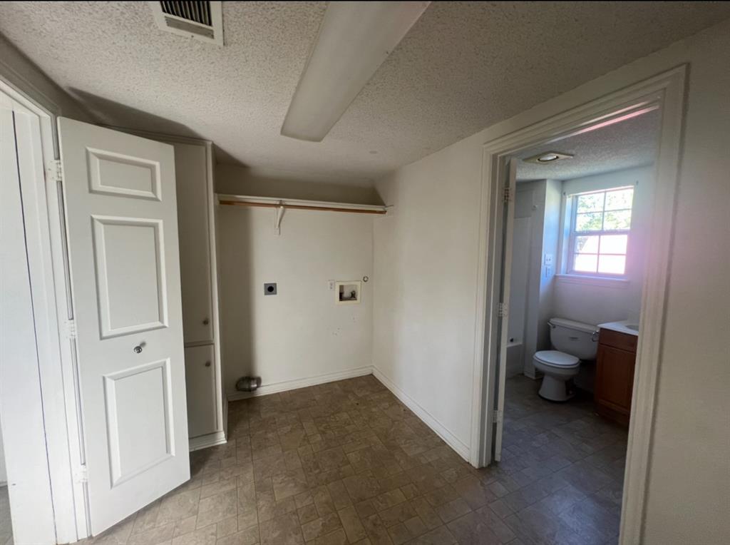 3133 Tbd County Road Lone Oak, TX 75453 - Photo 8 of 21 Dedicated laundry area featuring a wall-mounted drying rack and utility hookups