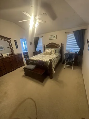 a spacious bedroom with a bed and a cabinets