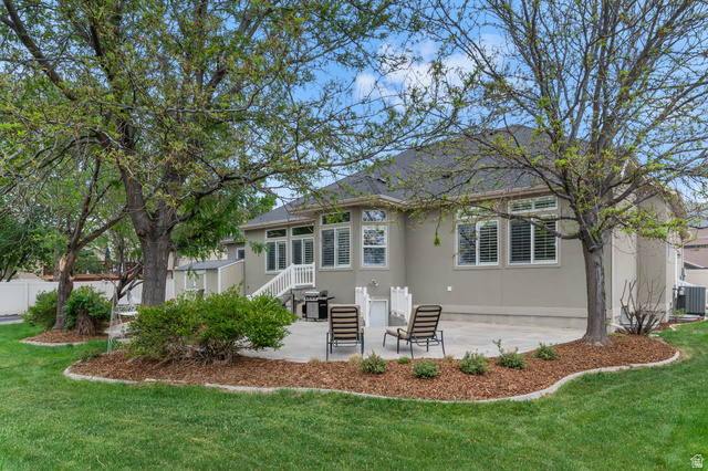 439 East 13540 South Draper, UT 84020 - Photo 40 of 46 Expansive backyard featuring a stone patio, mature trees, and manicured lawn