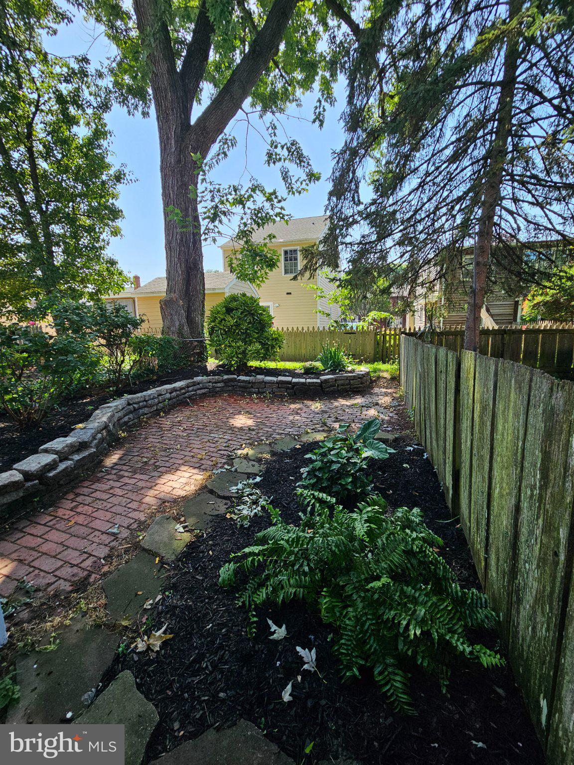 53 West 4th Street New Castle, DE 19720 - Photo 17 of 21 Serene garden path under leafy trees.