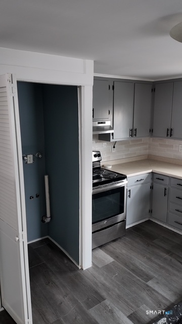 131 Ruth Street Bridgeport, CT 06606 - Photo 19 of 31 a kitchen with stainless steel appliances a stove and a refrigerator